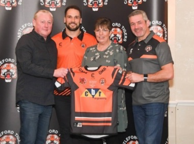 C&C members holding up Castleford Tigers shirt