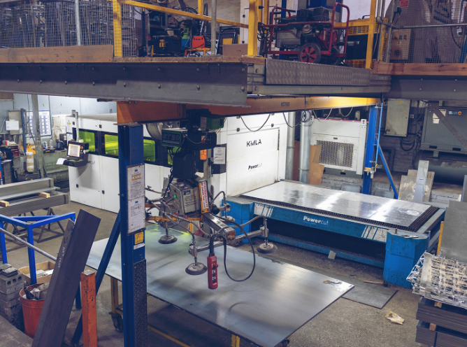 A overhead image of a very large plasma cutting table and cutter